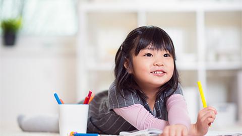 Child playing with pencil colors